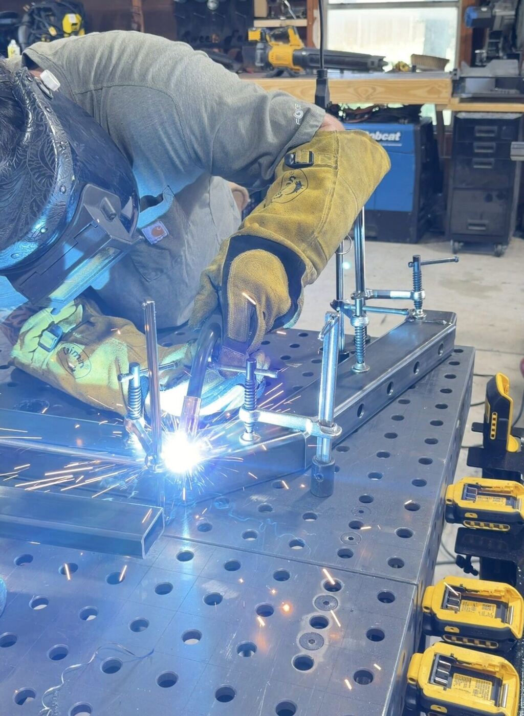 Peyton Sweet welding a steel part in the shop